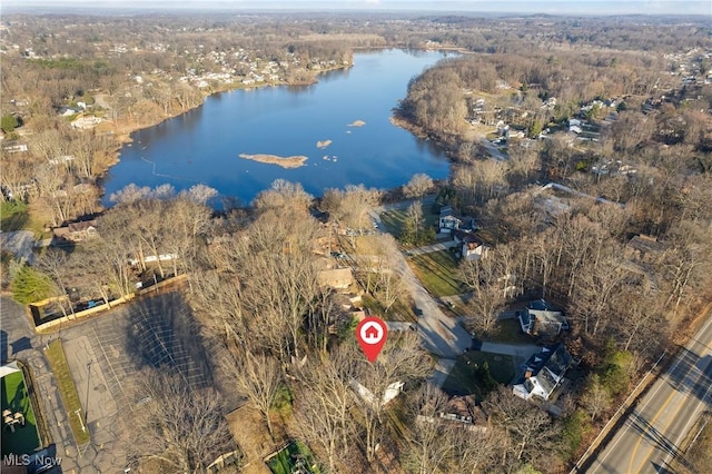 drone / aerial view featuring a forest view and a water view