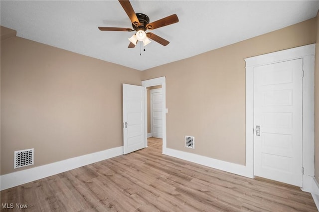 unfurnished room with visible vents, baseboards, a ceiling fan, and wood finished floors