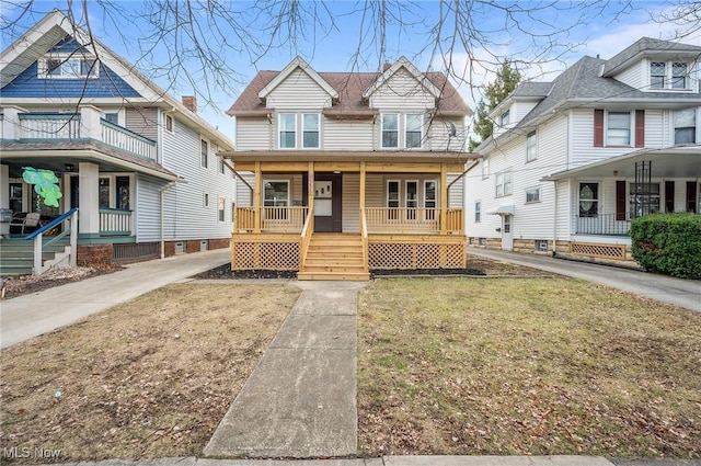 view of front of home with covered porch and a front yard