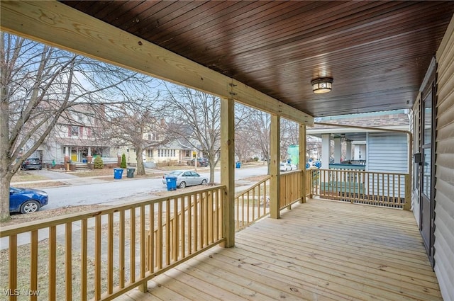 deck with a residential view and covered porch