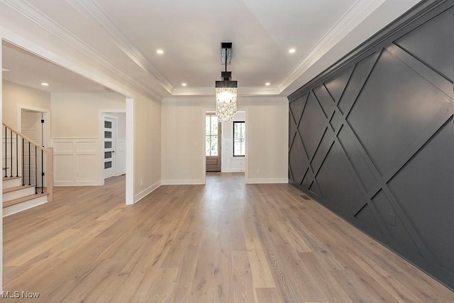2678 Rocky Ridge Dr, Westlake, OH 44145 - interior space featuring stairway, light wood-style floors, a decorative wall, a raised ceiling, and a chandelier