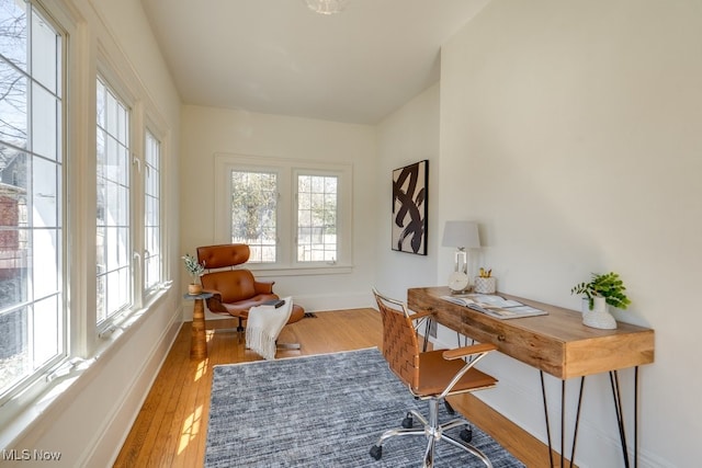 home office featuring baseboards and wood finished floors