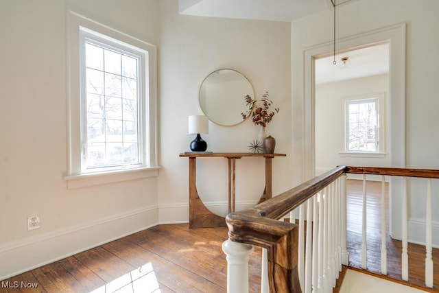 staircase featuring attic access, baseboards, and wood-type flooring