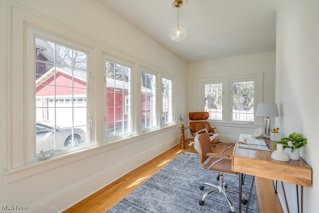 home office featuring plenty of natural light, wood finished floors, and baseboards