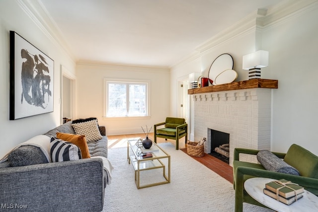 living area with a brick fireplace, wood finished floors, and crown molding