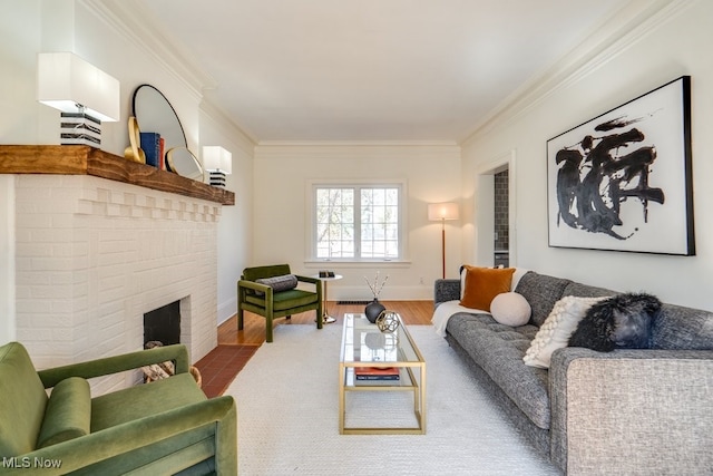 living area featuring a fireplace, crown molding, wood finished floors, and baseboards