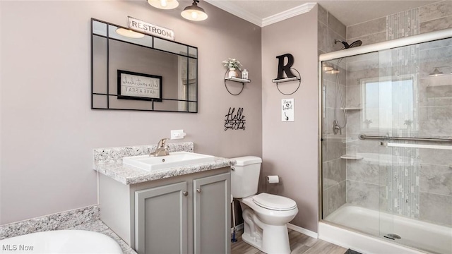 bathroom with a shower stall, crown molding, toilet, wood finished floors, and vanity