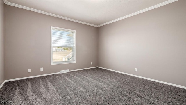 carpeted empty room with visible vents, baseboards, and ornamental molding