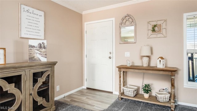 foyer with crown molding, baseboards, and wood finished floors