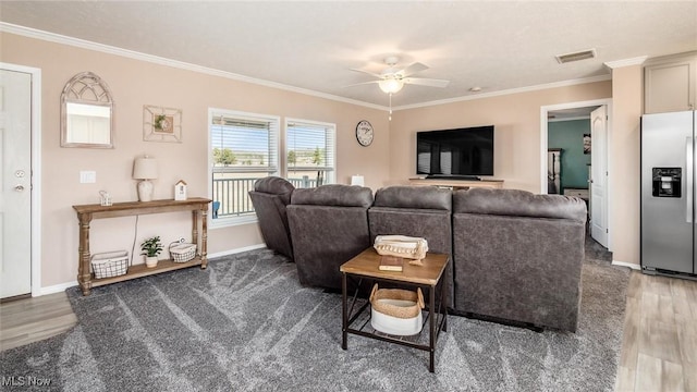 living area featuring visible vents, wood finished floors, ceiling fan, and crown molding