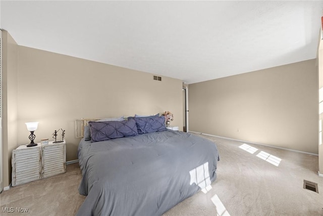 bedroom featuring visible vents, baseboards, and light colored carpet