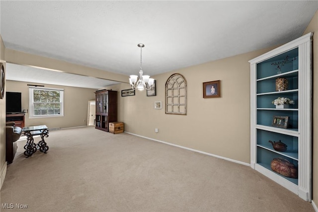 interior space with baseboards, carpet floors, and a chandelier