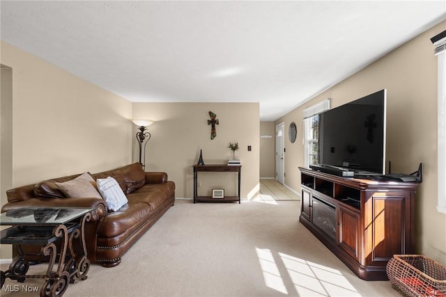 living room with baseboards and light carpet