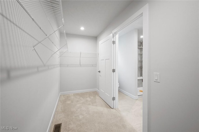 walk in closet featuring carpet flooring and visible vents