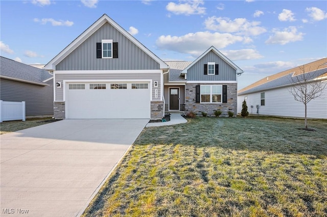 view of front facade featuring board and batten siding, a front lawn, and stone siding