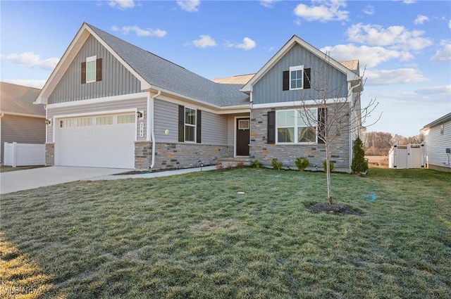 craftsman-style home featuring stone siding, a garage, board and batten siding, and a front lawn