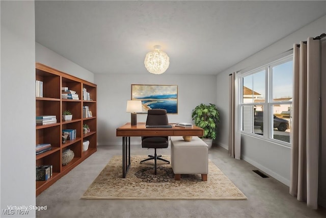 home office featuring an inviting chandelier, baseboards, and visible vents