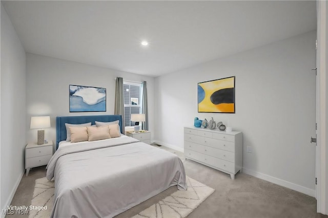 bedroom featuring baseboards and light carpet