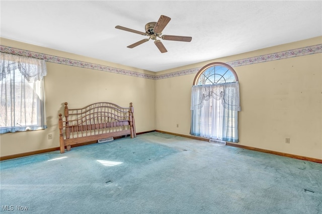 carpeted bedroom featuring visible vents, baseboards, and ceiling fan