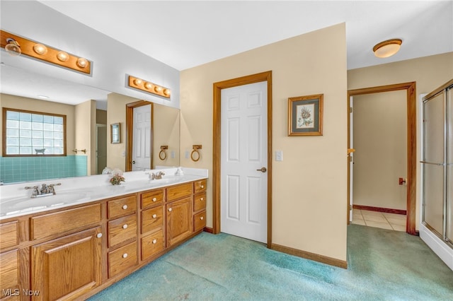 bathroom featuring a sink, carpet flooring, a shower with shower door, and double vanity