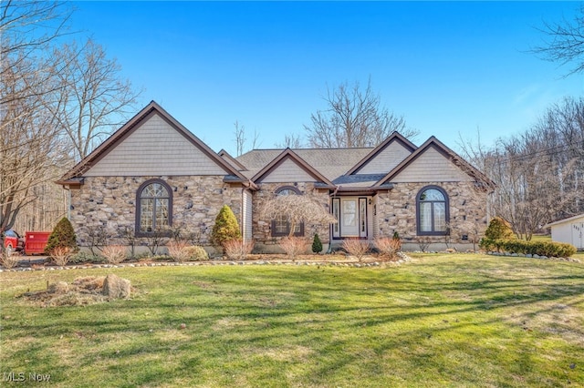 view of front of house with a front lawn and stone siding