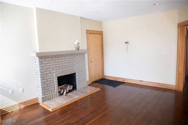 unfurnished living room featuring a fireplace, recessed lighting, wood finished floors, and baseboards