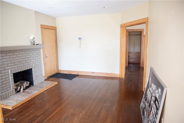 living area with recessed lighting, baseboards, wood finished floors, and a fireplace