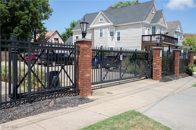 view of gate with a fenced front yard