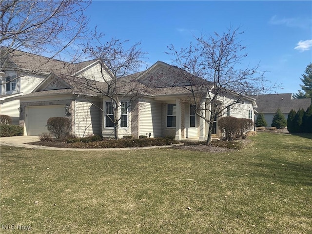 view of front of home with a garage, brick siding, concrete driveway, and a front lawn