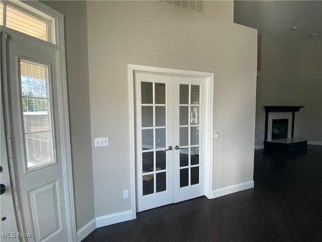 entryway with french doors, baseboards, visible vents, and dark wood-style floors