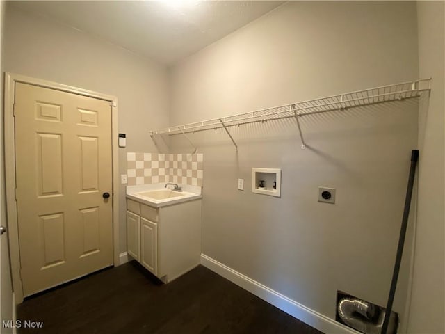 laundry room with baseboards, hookup for a washing machine, cabinet space, electric dryer hookup, and a sink