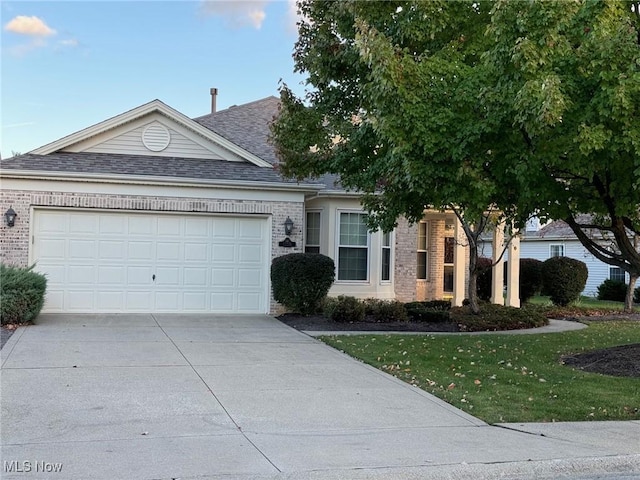 ranch-style house with brick siding, driveway, and an attached garage