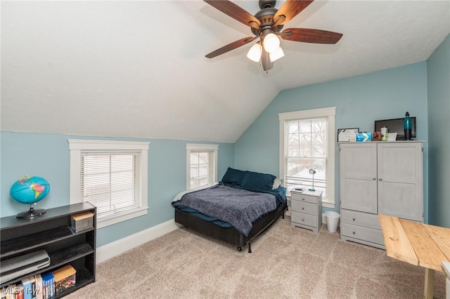 bedroom featuring baseboards, lofted ceiling, carpet, and ceiling fan