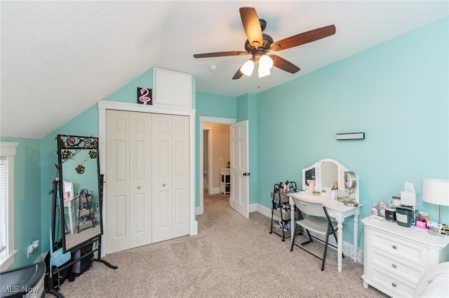 office with a ceiling fan, lofted ceiling, light colored carpet, and baseboards