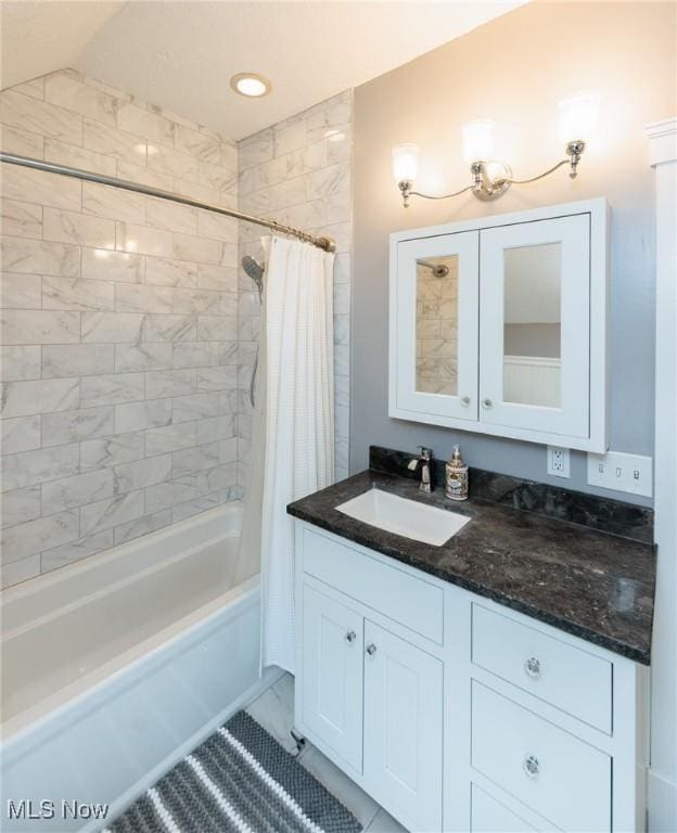 bathroom with shower / tub combo, lofted ceiling, and vanity