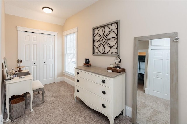 home office with lofted ceiling, light colored carpet, and baseboards