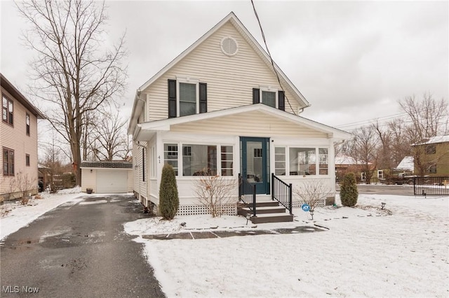 view of front of home with driveway and an outdoor structure