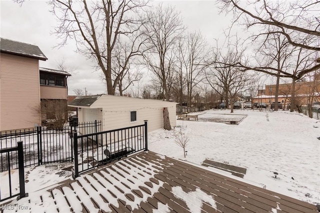 snow covered deck featuring fence