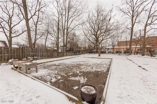 yard covered in snow featuring fence