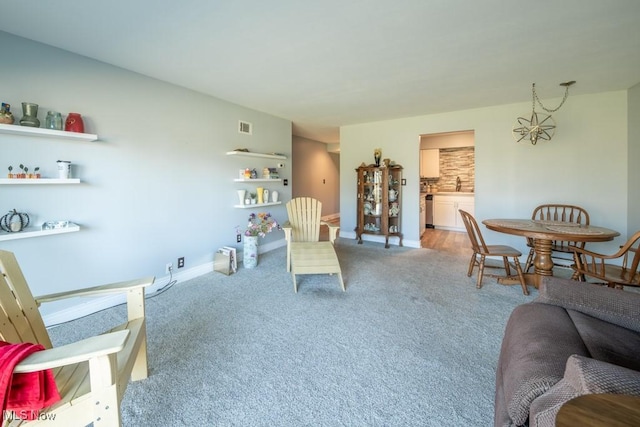 living room featuring light carpet, visible vents, and baseboards