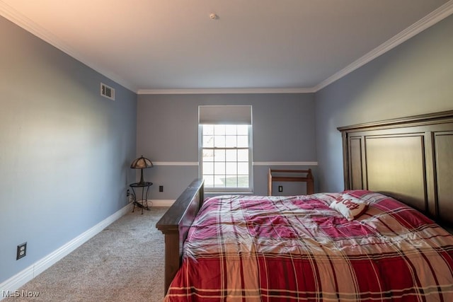 carpeted bedroom with visible vents, baseboards, and crown molding