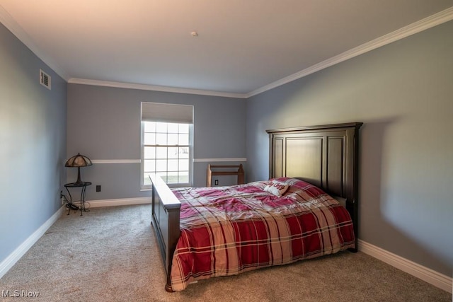 carpeted bedroom with visible vents, baseboards, and ornamental molding