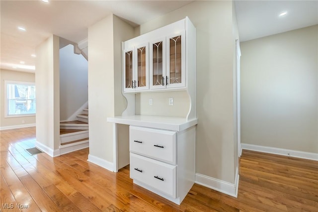 hallway with baseboards and light wood-type flooring