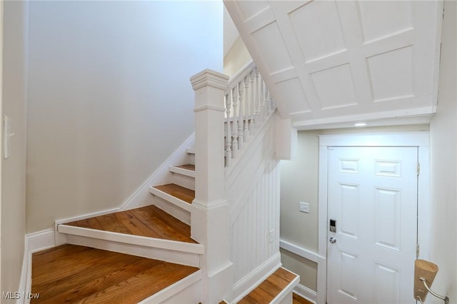 stairway featuring baseboards and wood finished floors