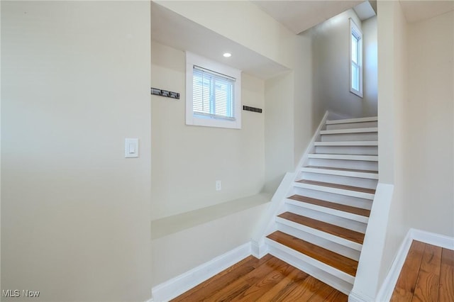 stairs featuring recessed lighting, baseboards, and wood finished floors