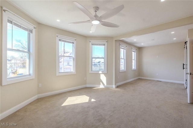 empty room featuring baseboards and plenty of natural light