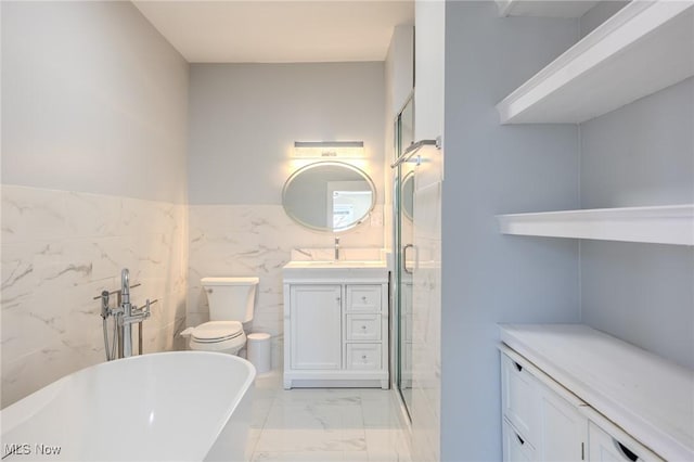 full bath with a shower stall, toilet, a freestanding tub, marble finish floor, and vanity