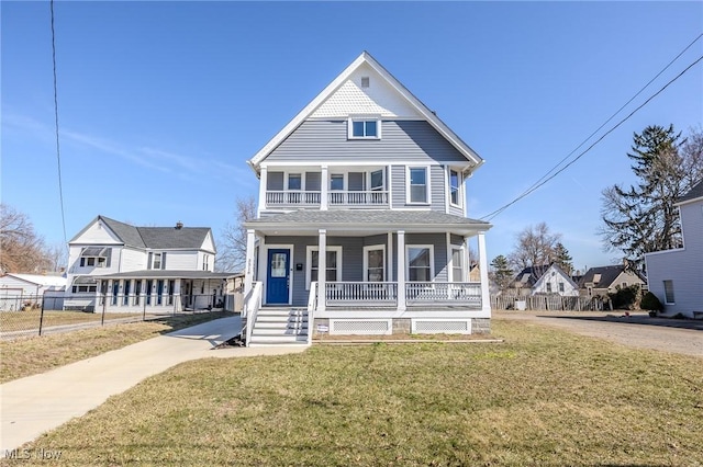 view of front facade with covered porch and a front yard