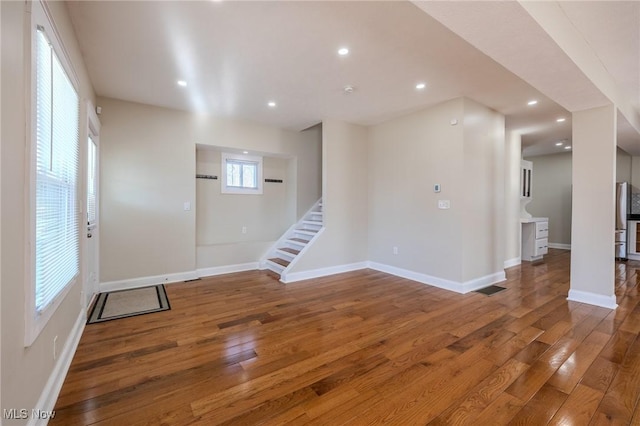 interior space featuring hardwood / wood-style flooring, stairway, recessed lighting, and baseboards