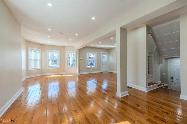 unfurnished living room featuring recessed lighting, light wood-type flooring, and baseboards